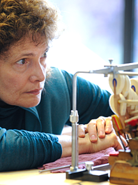 A woman looking at a toy crane.